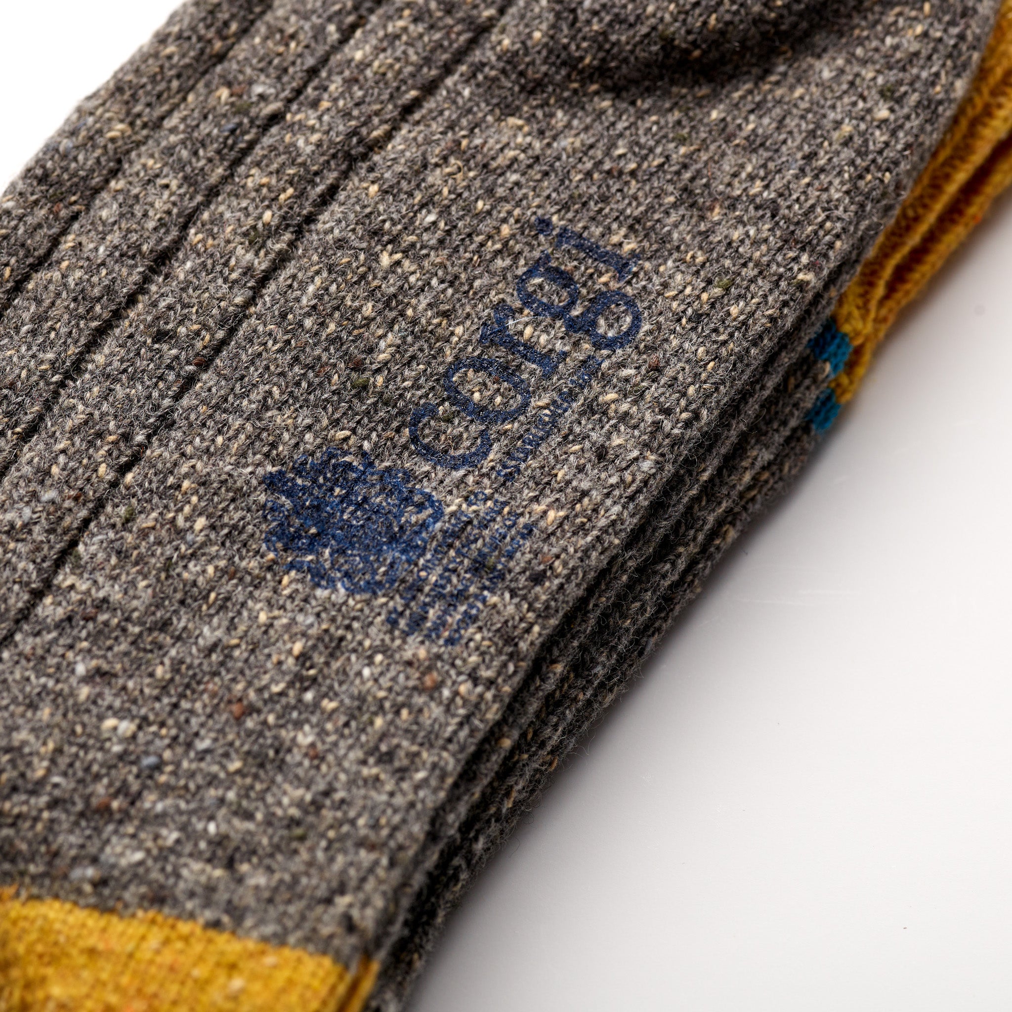 Corgi Heavyweight Colour Block Donegal Socks in Grey & Gold foot logo and knit texture close-up