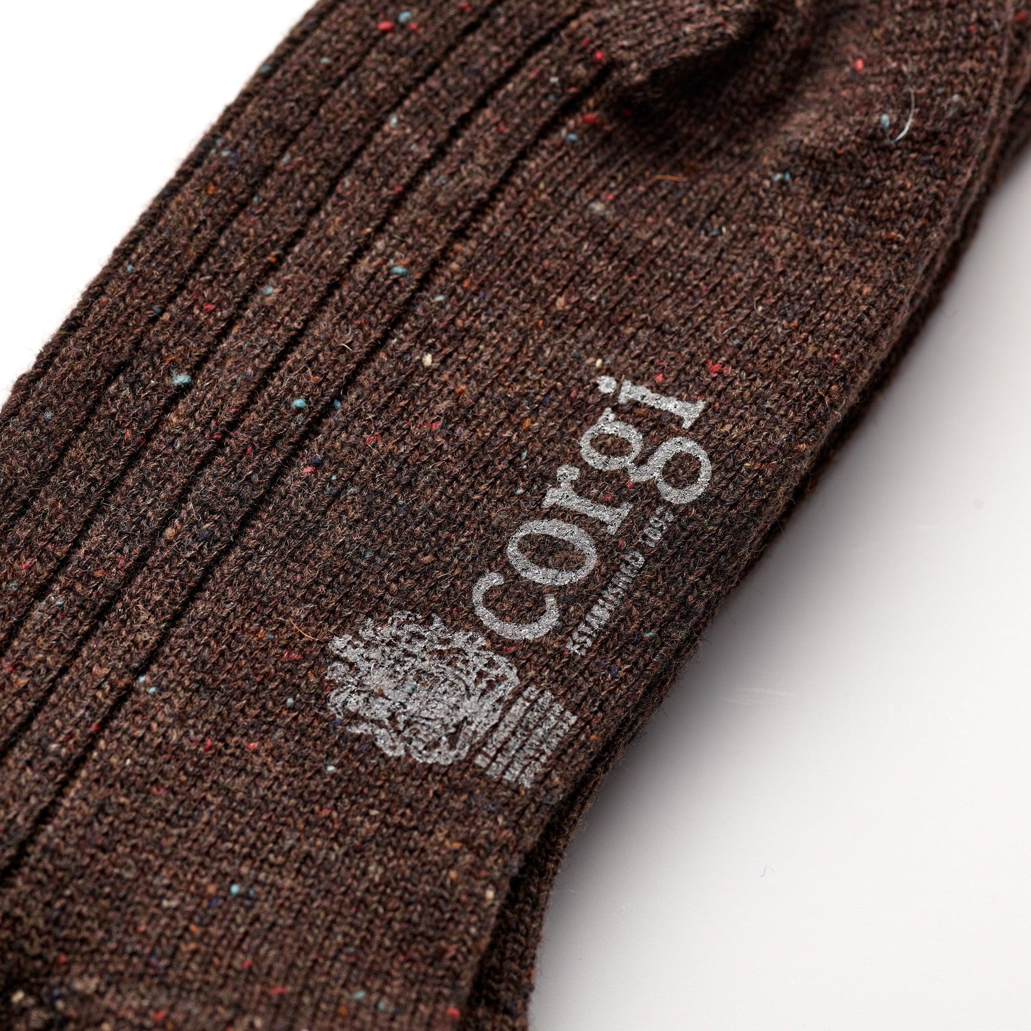 Corgi Heavyweight Plain Donegal Socks in Chocolate foot logo and knit texture close-up