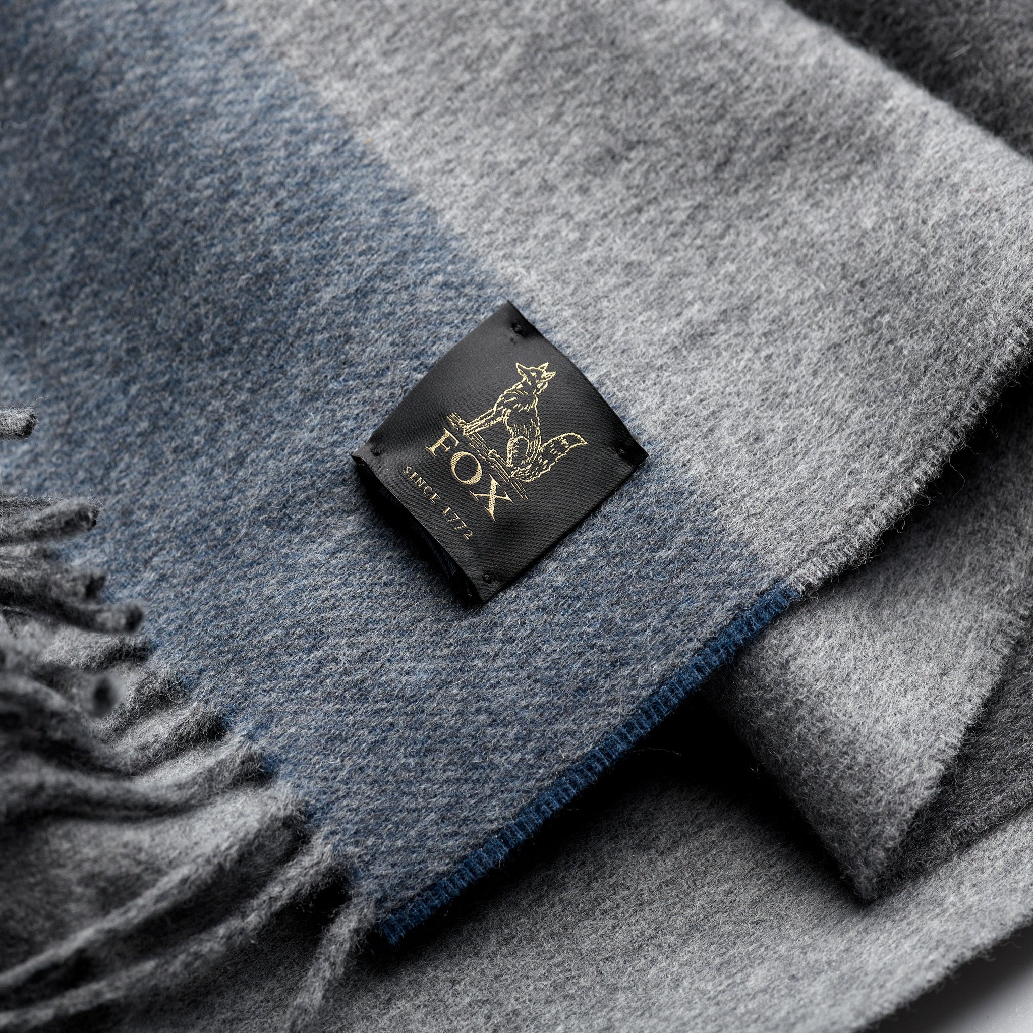 Fox woven label on grey and blue cashmere and wool brushed scarf