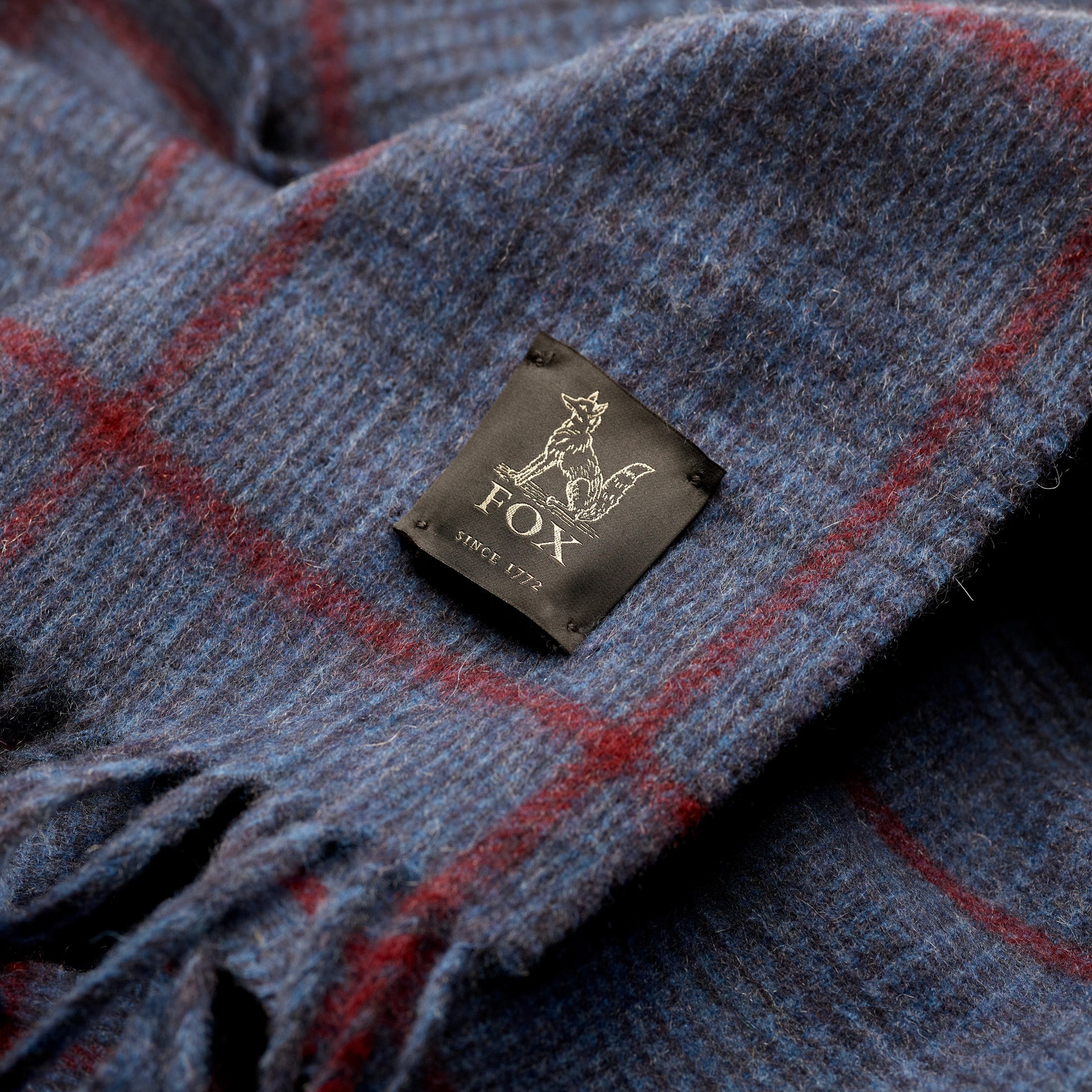 Fox woven label on navy heather and crimson cashmere scarf
